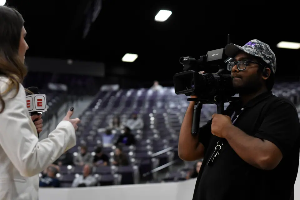Camera operator framing a shot through the viewfinder on set