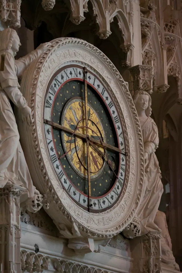 The cathedral's carved astronomical clock face set into its stone surround