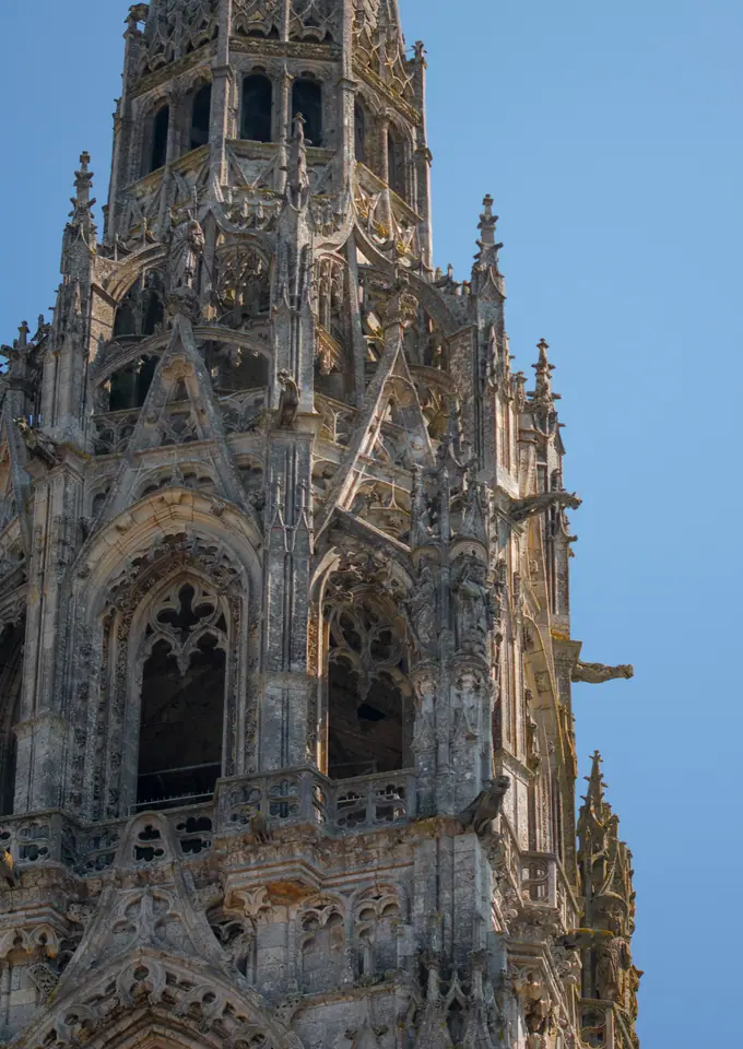 The pierced Gothic spire of Chartres Cathedral against a clear blue sky