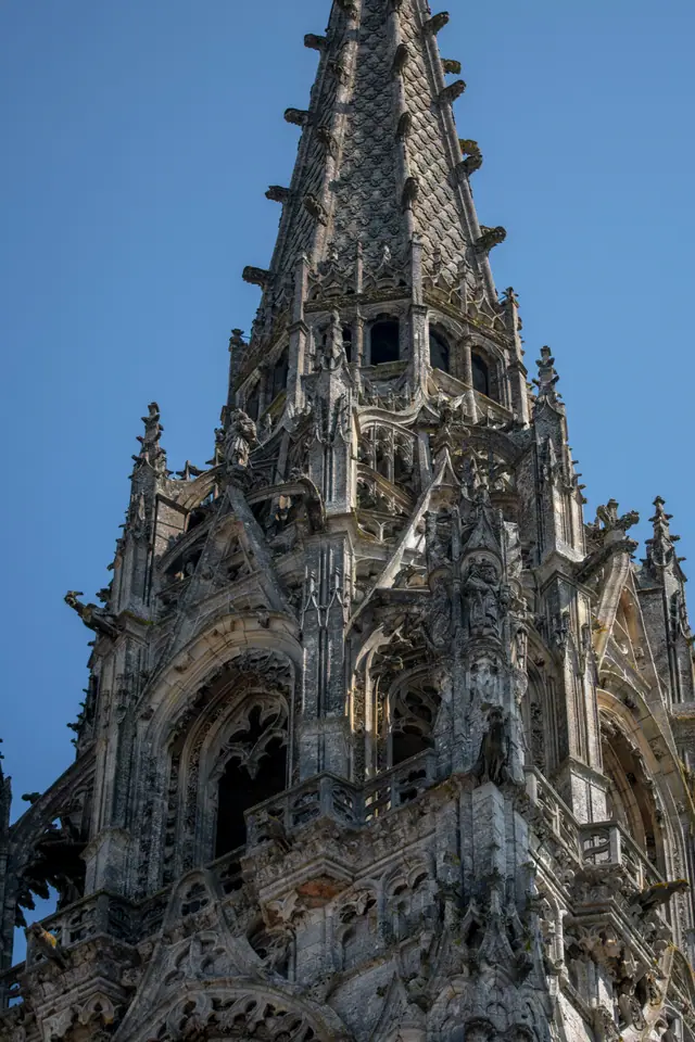 Stone tracery and pinnacles of a Chartres Cathedral spire seen from below