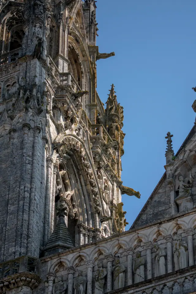 Tower and flying buttresses of Chartres Cathedral rising above the nave roofline