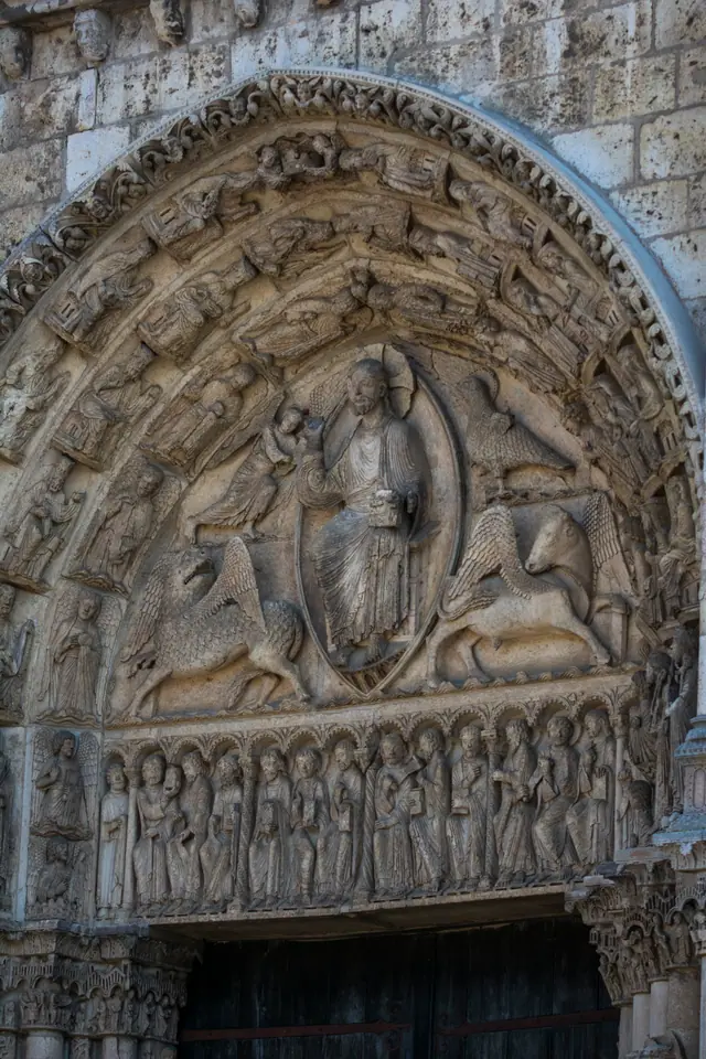 Romanesque tympanum above a Chartres Cathedral doorway showing Christ in Majesty within a mandorla