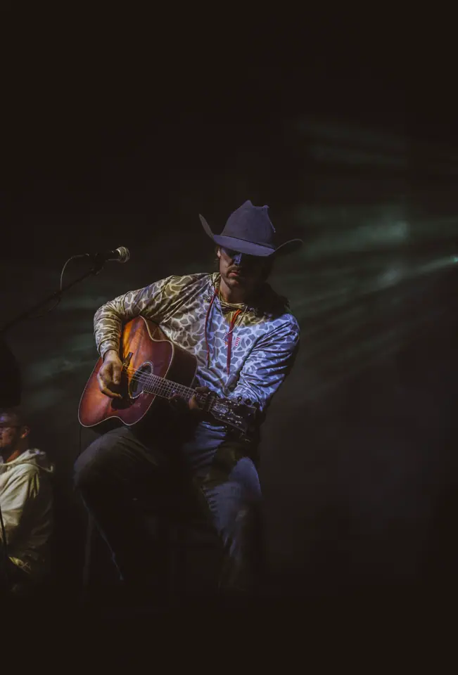 Performer mid-set under stage lighting